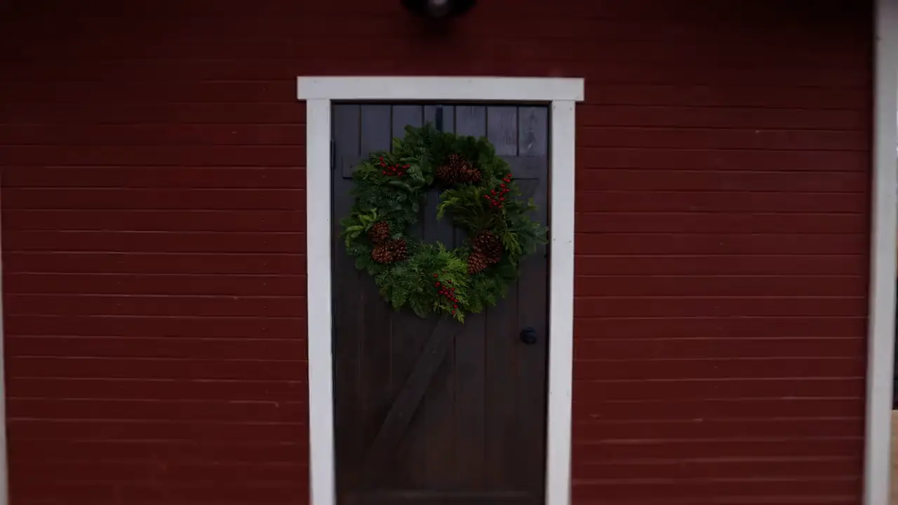 The red Löyly sauna cabin in Burley, Idaho, a wreath on its door
